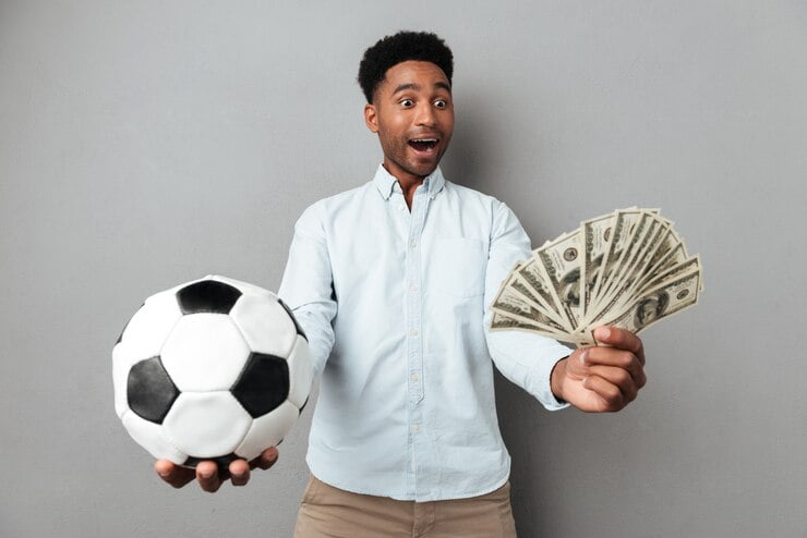 happy-smiling-african-man-showing-football-money-banknotes